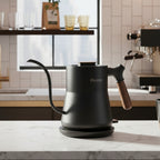 Black coffee kettle with wooden handle on a white background, featuring the Rainbean brand.